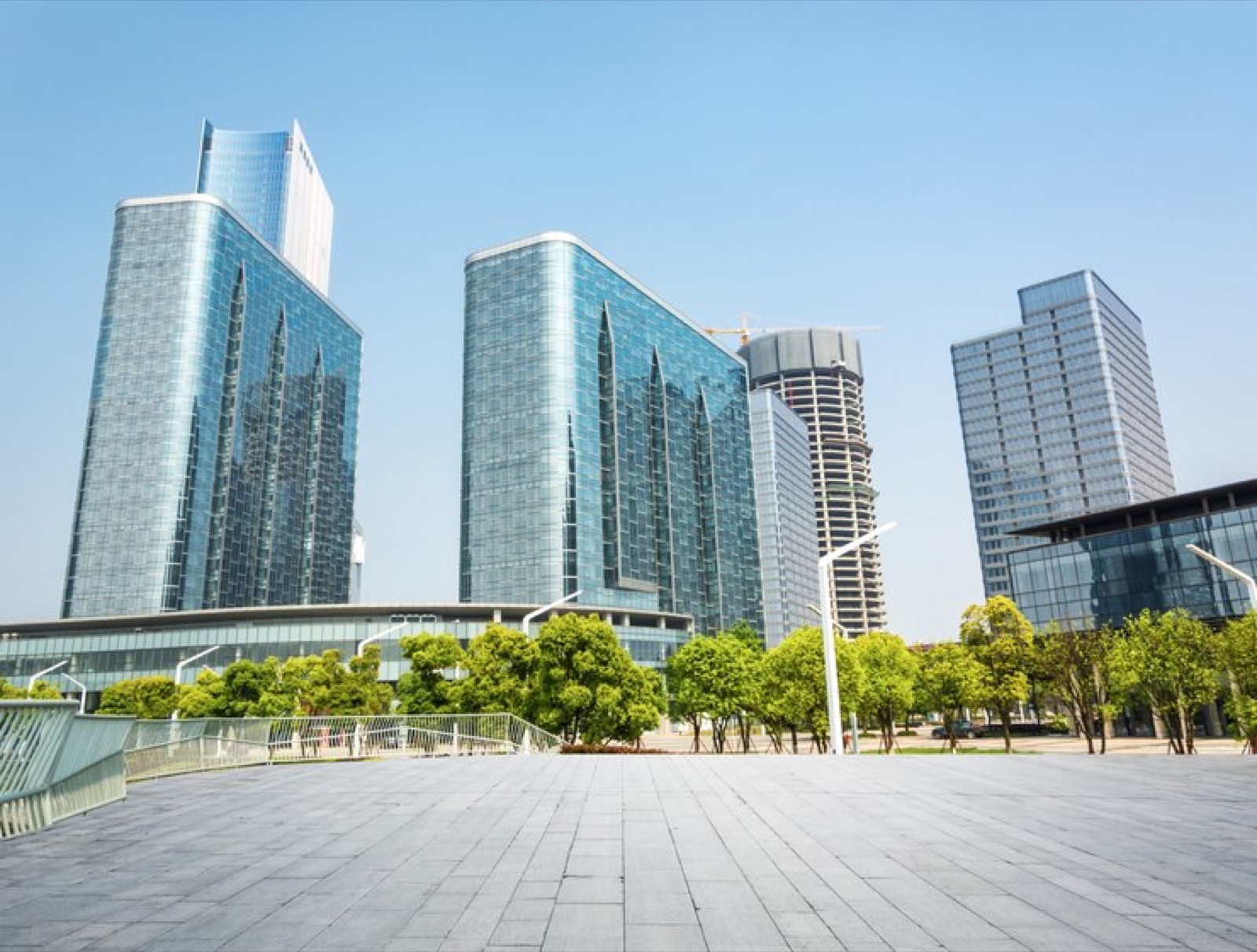 Glass office towers around a landscaped plaza